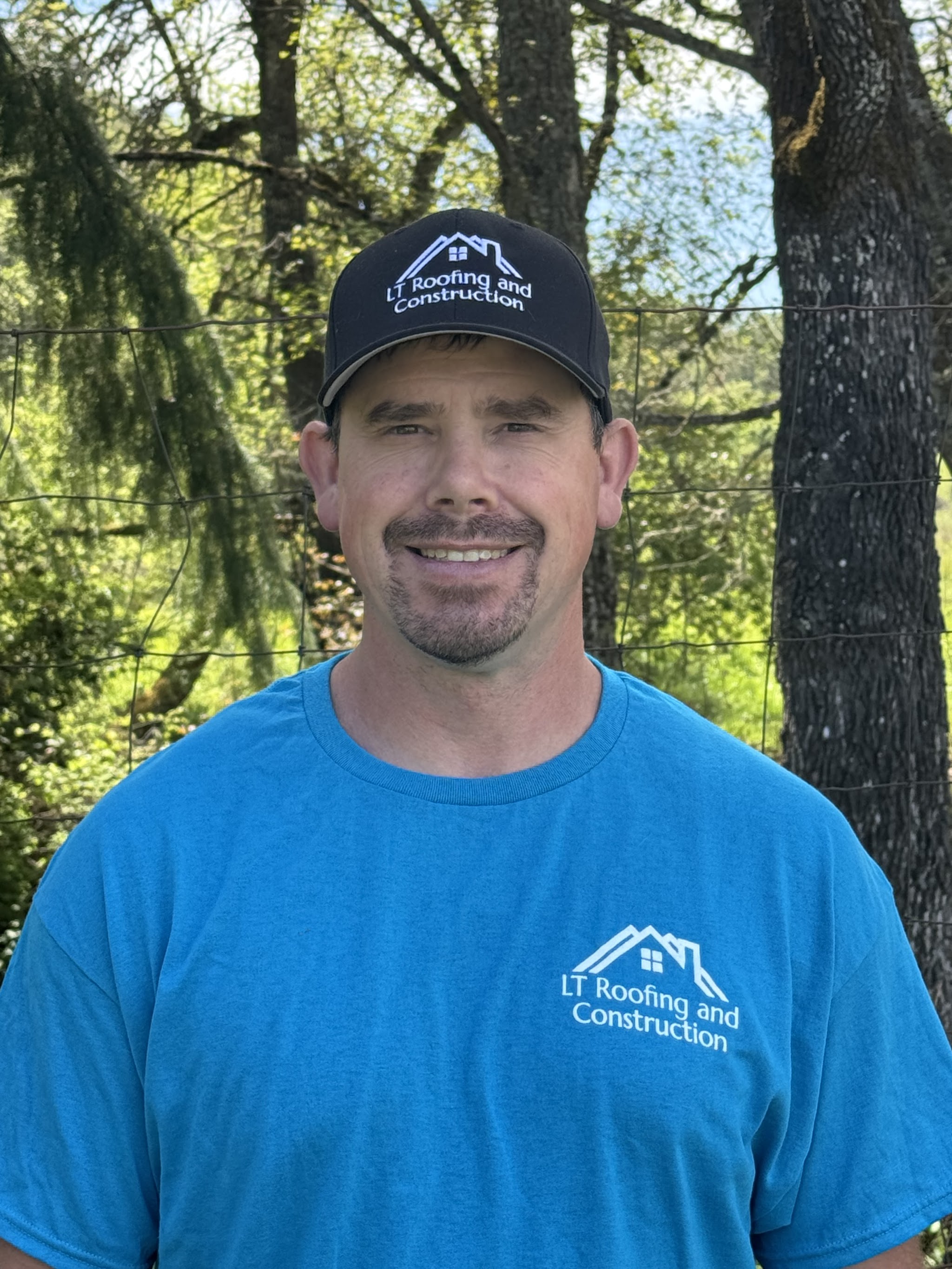 Logan Thom, owner of LT Roofing and Construction, in a company cap and shirt